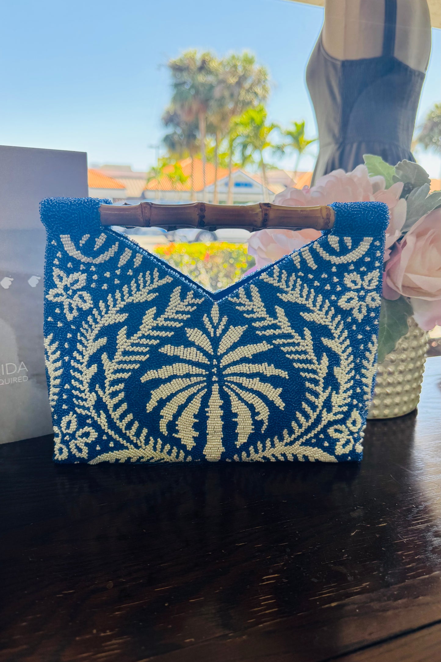 Blue and White Beaded Clutch Handbag with Bamboo Handle from Southern Sunday Boutique in Naples, FL